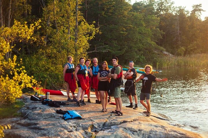 Fika stop on smooth granite rocks during the Vaxholm kayak & fika tour — archipelago nature break.