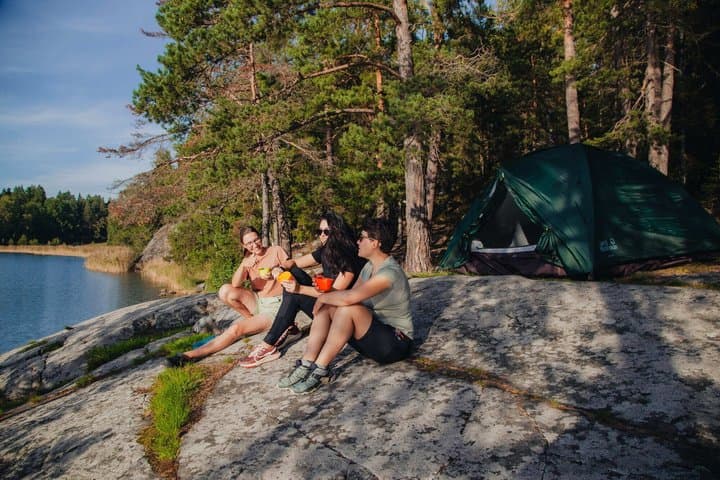 Wild camp in the archipelago: evening on smooth granite rocks after a full day of guided sea kayaking.